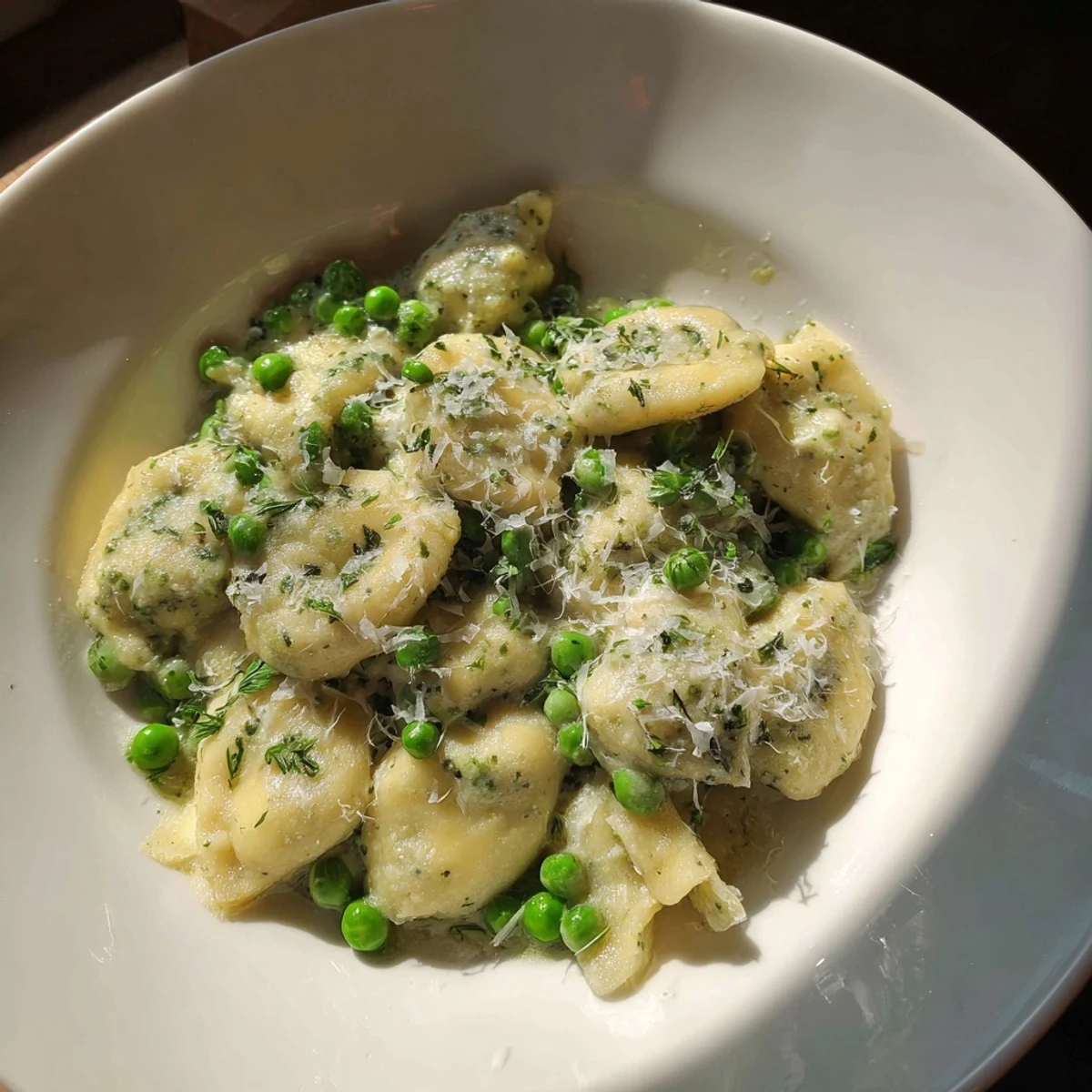 Creamy Parmesan Orzo with lush green peas, ready to serve in a warm, inviting bowl.