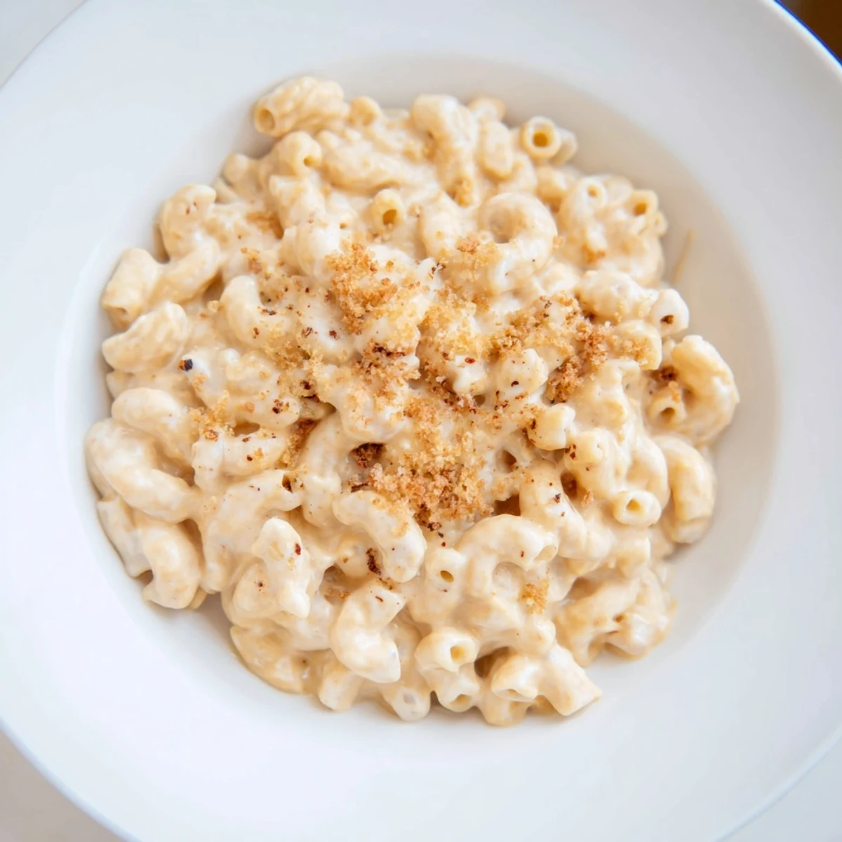 A steaming bowl of pumpkin mac & cheese, creamy and golden, ready to serve.
