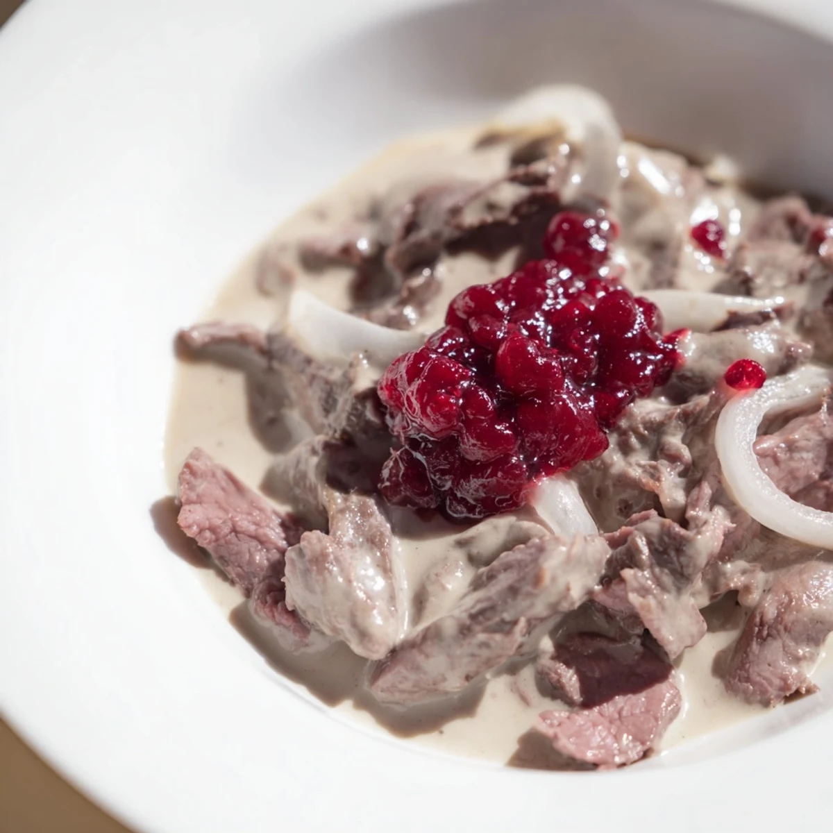 Imagine rich Finnish Reindeer Stew: perfectly cooked reindeer, savory broth, and a vibrant side of berries.