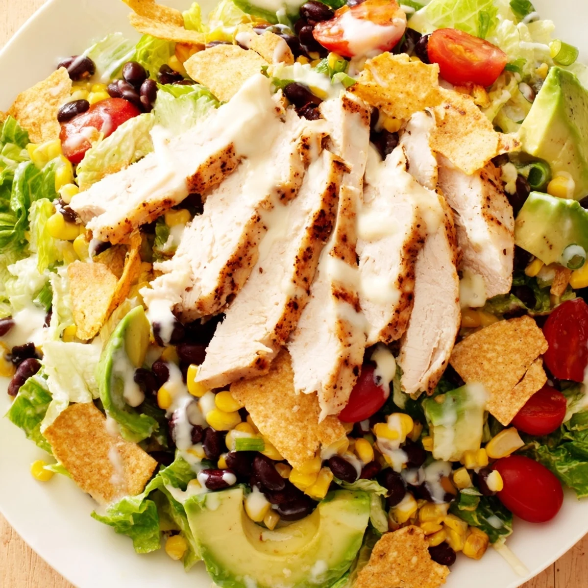Crunchy Taco Chicken Salad served in a rustic bowl with seasoned chicken, crisp lettuce, and vibrant corn and black beans.