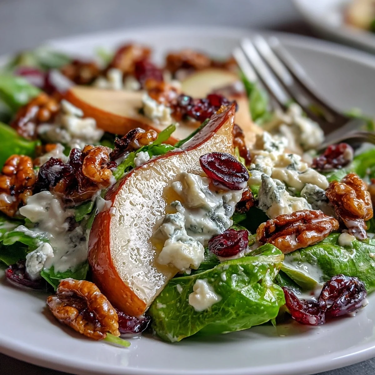 Juicy sliced pears and crumbled Gorgonzola cheese top a bed of mixed greens with toasted walnuts and a honey-balsamic vinaigrette, served as a fresh vegetarian salad.