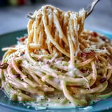 Freshly grated Pecorino Romano and cracked pepper create a glossy sauce in this classic Cacio e Pepe.