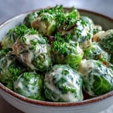 Roasted Brussels sprouts tossed in a silky cream cheese sauce with garlic and onions.