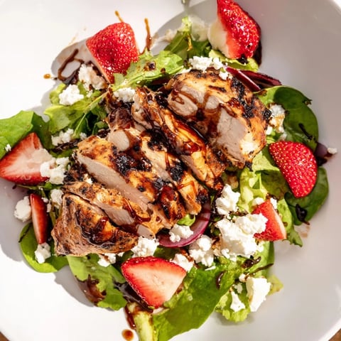 Grilled chicken slices, sliced strawberries, and crumbled goat cheese tossed in honey balsamic glaze on fresh mixed greens.