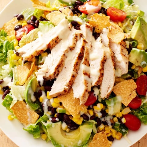 Crunchy Taco Chicken Salad served in a rustic bowl with seasoned chicken, crisp lettuce, and vibrant corn and black beans.