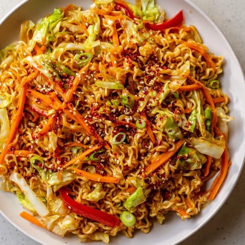 Vibrant photo of spicy ramen stir fry with colorful vegetables and savory sauce, ready to eat.