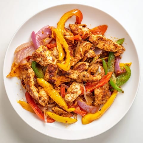 Flavorful sheet-pan chicken fajitas, showcasing perfectly roasted chicken strips with colorful vegetables for dinner.