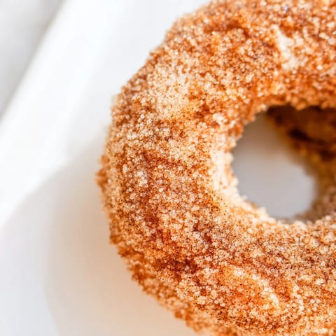 Fluffy donut shapes from biscuit dough, brushed with melted butter and tossed in sweet cinnamon sugar while still hot.