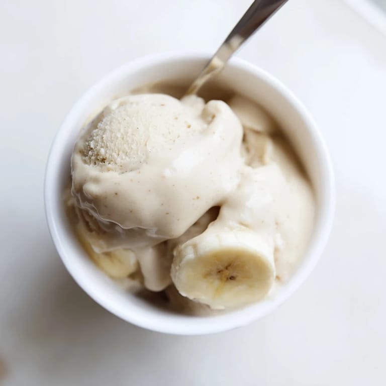Creamy 2-Ingredient Banana Ice Cream, served in a bowl, boasts a naturally sweet flavor profile.