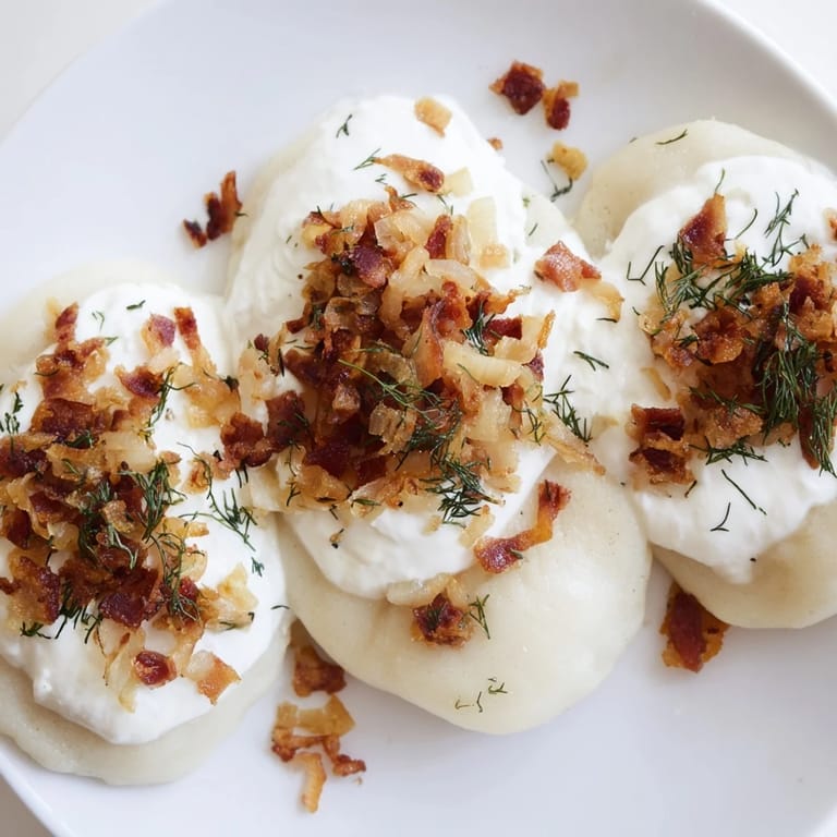 Tender, oval-shaped Cepelinai, filled with seasoned meat, smothered with a creamy bacon sauce.