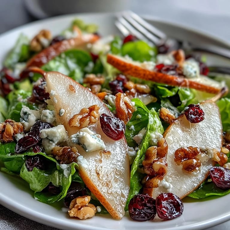 Pear Gorgonzola Salad with tangy cheese, sweet pears, crisp greens, and toasted walnuts, lightly dressed for a refreshing starter or light vegetarian meal.