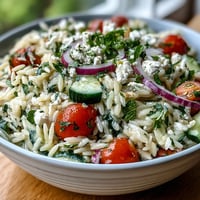 Fresh orzo salad with cucumber, feta, and zesty lemon dressing, perfect for a light Mediterranean lunch.  